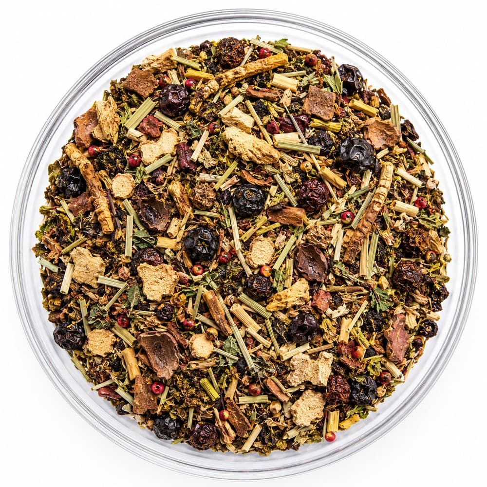 Steady Flame™ loose-leaf blend in a glass bowl — dark berries, pale lemongrass, dried apple pieces and pink peppercorns